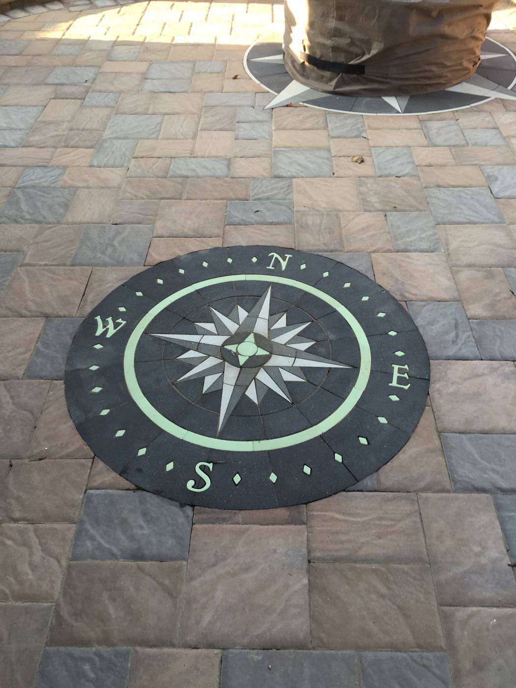 Compass rose inlay set in a commercial paver patio