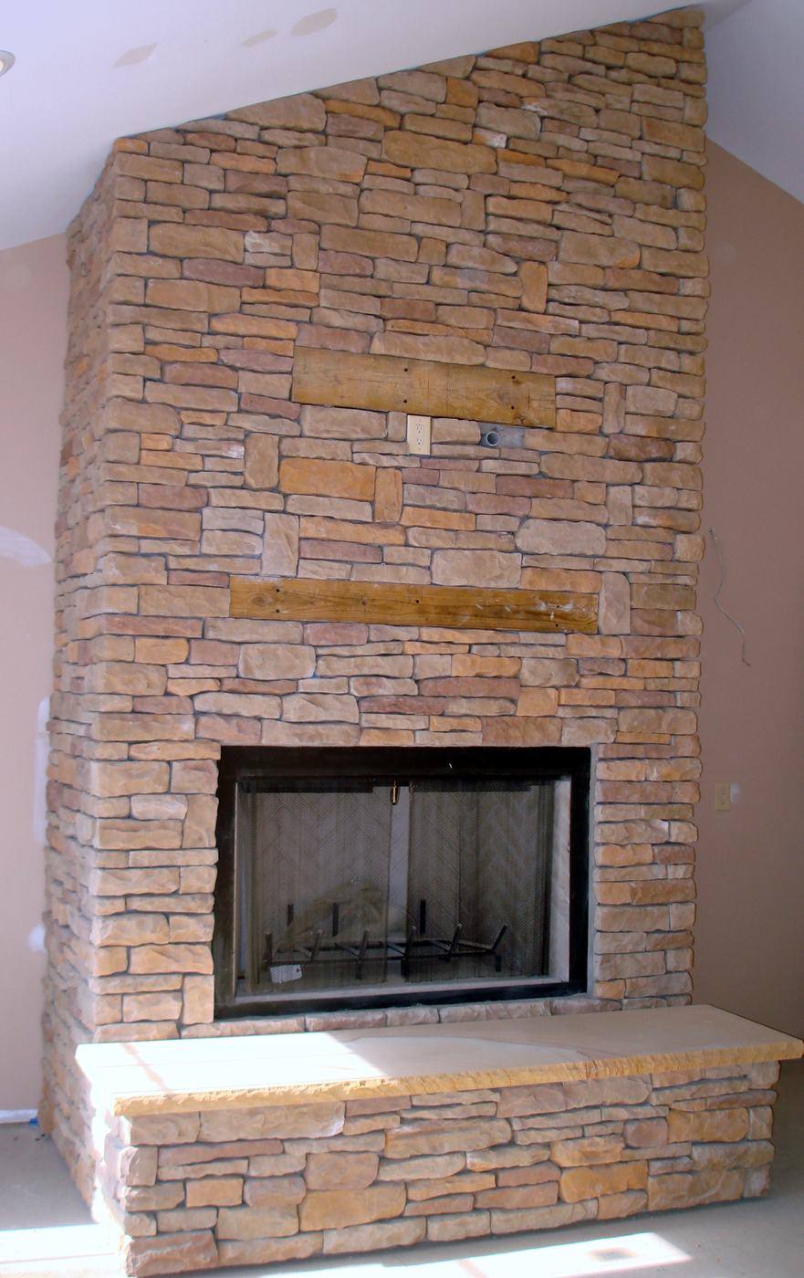 Floor-to-ceiling stacked stone fireplace