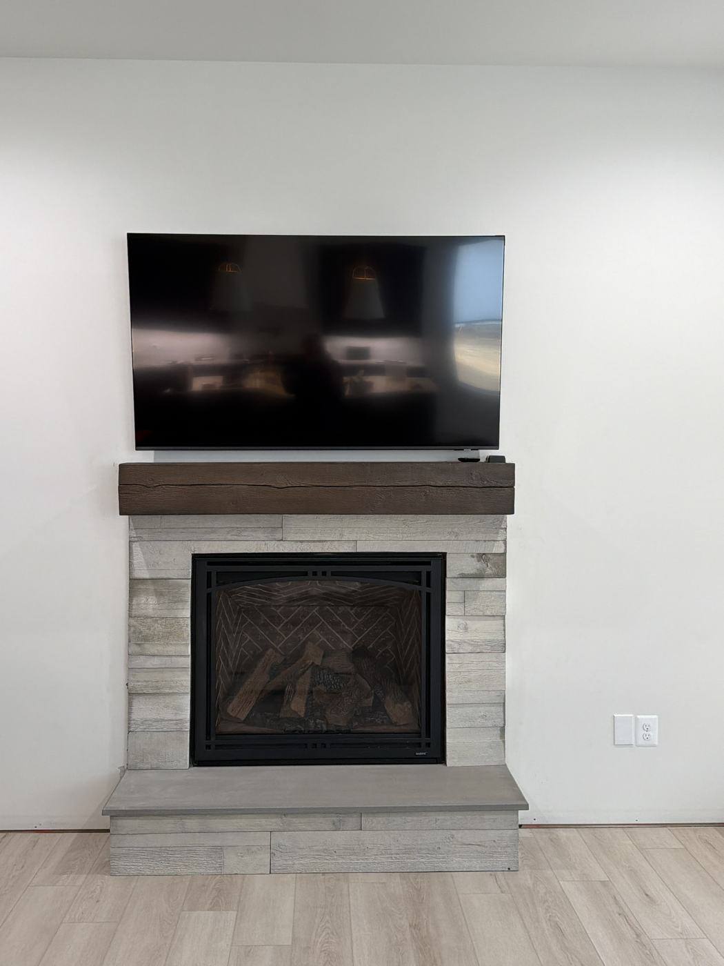 Stone-veneer fireplace with a wood mantel