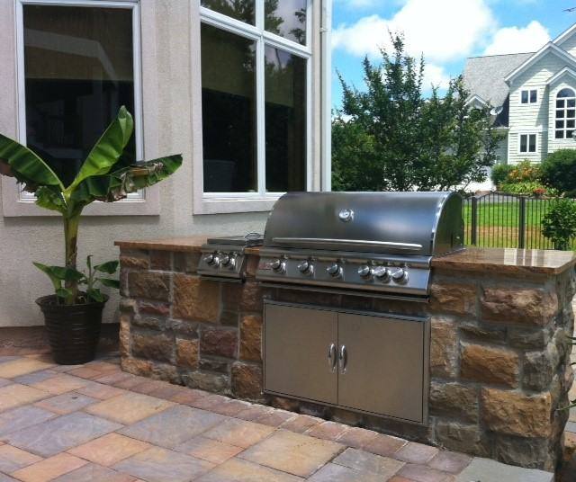 Built-in grill with stone veneer on a paver patio in Leonardtown, MD