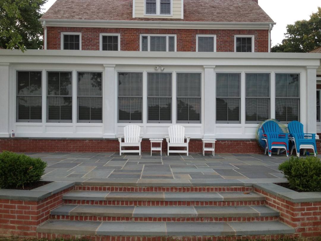 Flagstone patio and brick steps along a sunroom