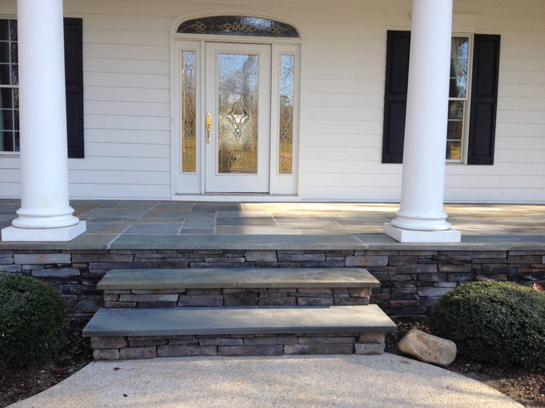 Front porch steps with stone veneer and bluestone treads