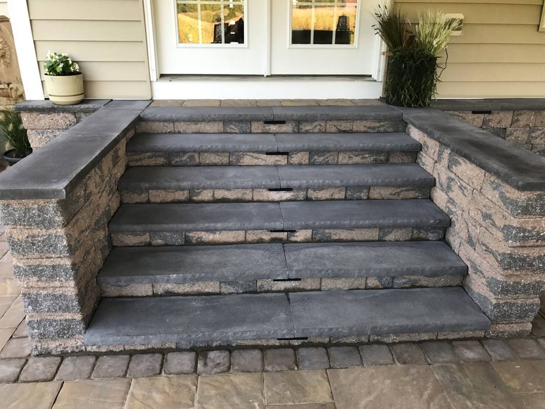 Stacked-stone steps with bluestone caps on a paver patio